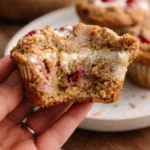 Vegan gluten-free strawberries and cream muffins on a wooden table