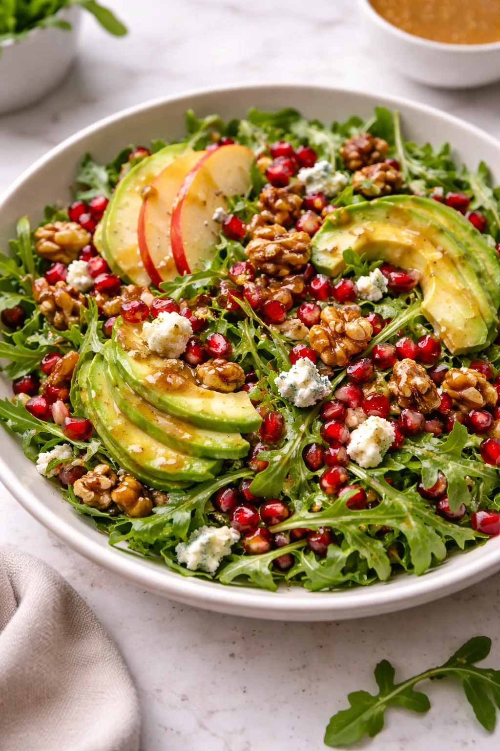 Winter Christmas Salad topped with honey mustard dressing and vibrant seasonal ingredients