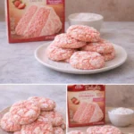 Freshly baked crinkle cookies dusted with powdered sugar on a plate.
