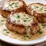 Easy pork chops served in creamy garlic sauce on a plate