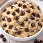Bowl of Greek Yogurt Cookie Dough with chocolate chips and a spoon.