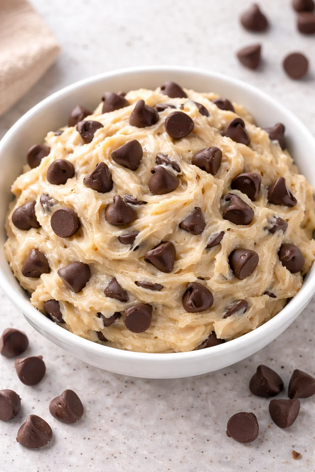 Bowl of Greek Yogurt Cookie Dough with chocolate chips and a spoon.