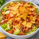 A colorful bowl of Simple Doritos Taco Salad with crunchy toppings and fresh ingredients.