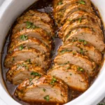Succulent slow cooker pork tenderloin served with vegetables.