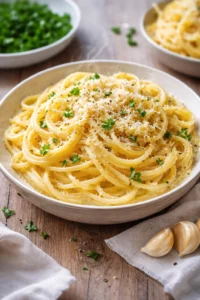 Creamy garlic butter pasta garnished with herbs in a delicious bowl