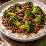 Stir-fried ground beef with broccoli and sauce in a skillet