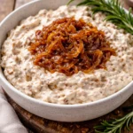 Delicious caramelized onion dip served in a bowl with fresh vegetables