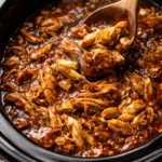 Delicious Crockpot Honey Garlic Chicken dish garnished with green onions.