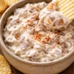 Delicious caramelized onion dip served in a bowl with chips.