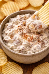 Delicious caramelized onion dip served in a bowl with chips.
